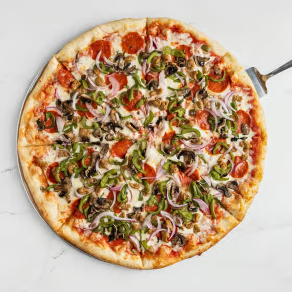 Big City Slices' pepperoni, mushroom, onion, and green pepper pizza on a metal tray.